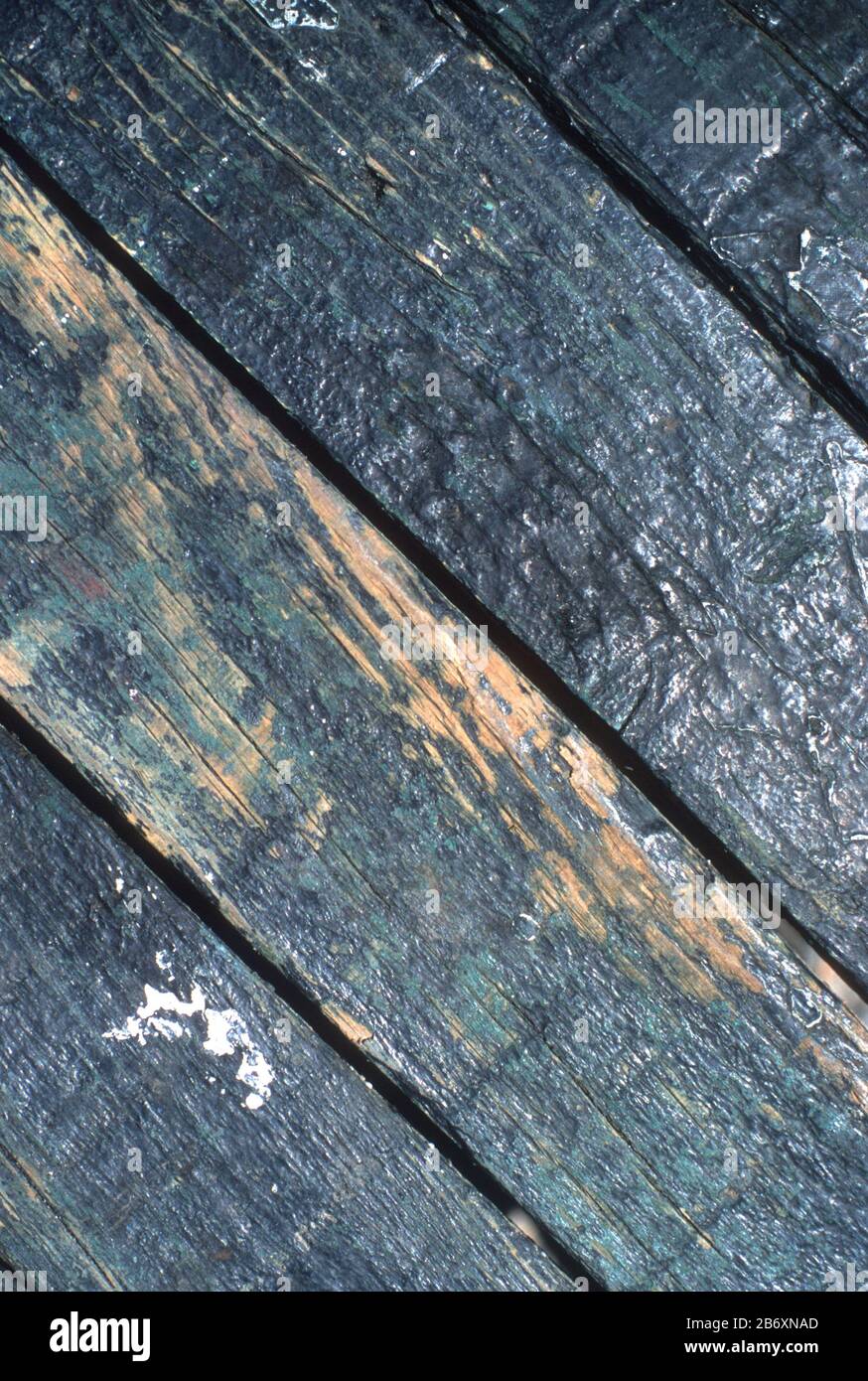 Black stained, rough wooden planking with worn paint in Loutro, Crete, Greece Stock Photo