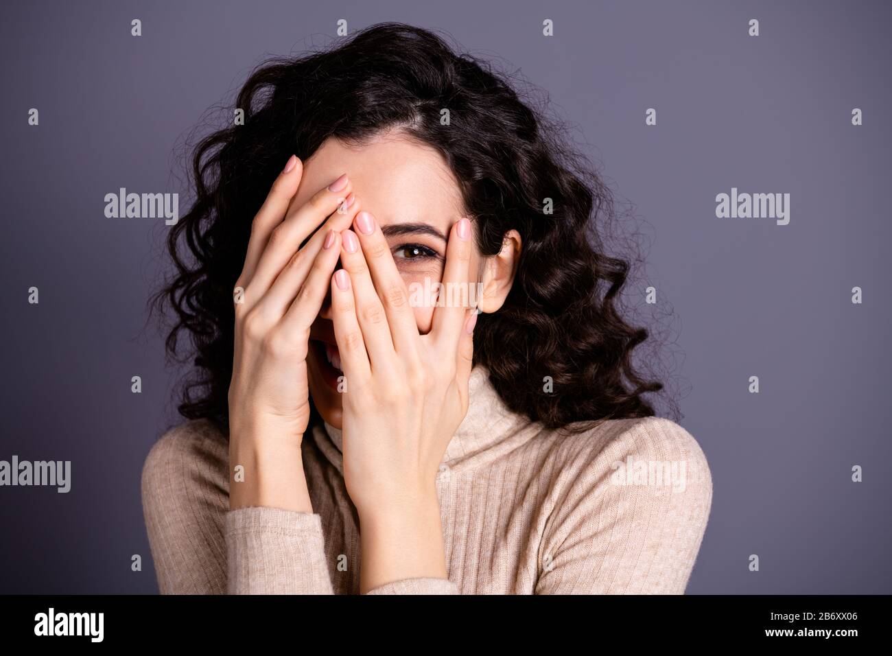 Hiding face behind fingers hires stock photography and images Alamy