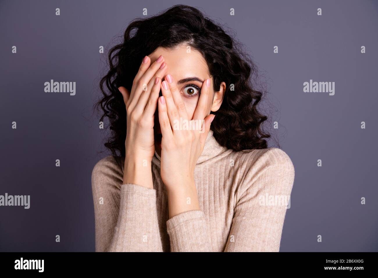 Hiding face behind fingers hires stock photography and images Alamy