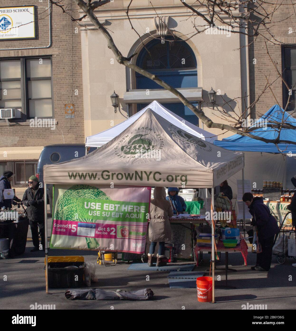 information tent at a farmers market in the Inwood neighborhood of manhattan. Local farmers sell fresh food directly to customers Stock Photo