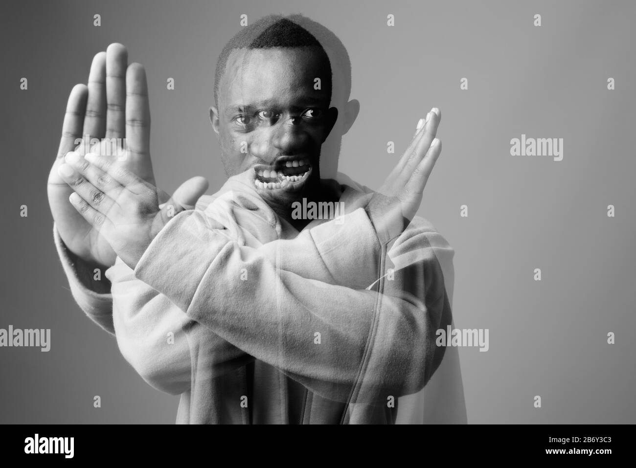 Portrait of young African man against gray background Stock Photo