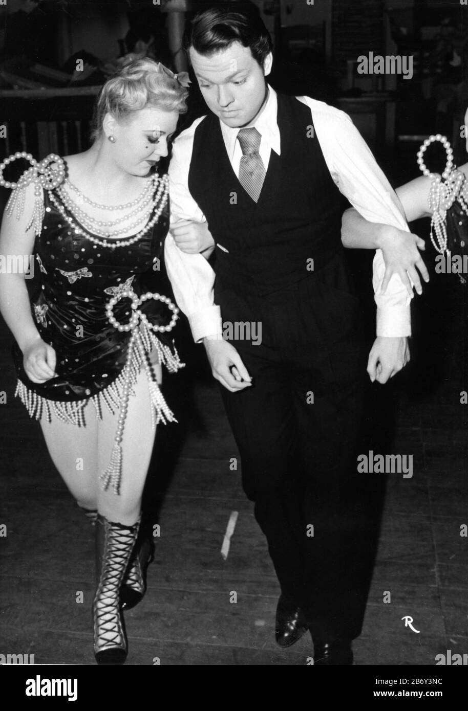 ORSON WELLES in costume as Charles Foster Kane rehearses dance with showgirl for Inquirer party scene in CITIZEN KANE 1941 director Orson Welles screenplay Herman J. Mankiewicz and Orson Welles music Bernard Herrmann Mercury Productions / RKO Radio Pictures Stock Photo