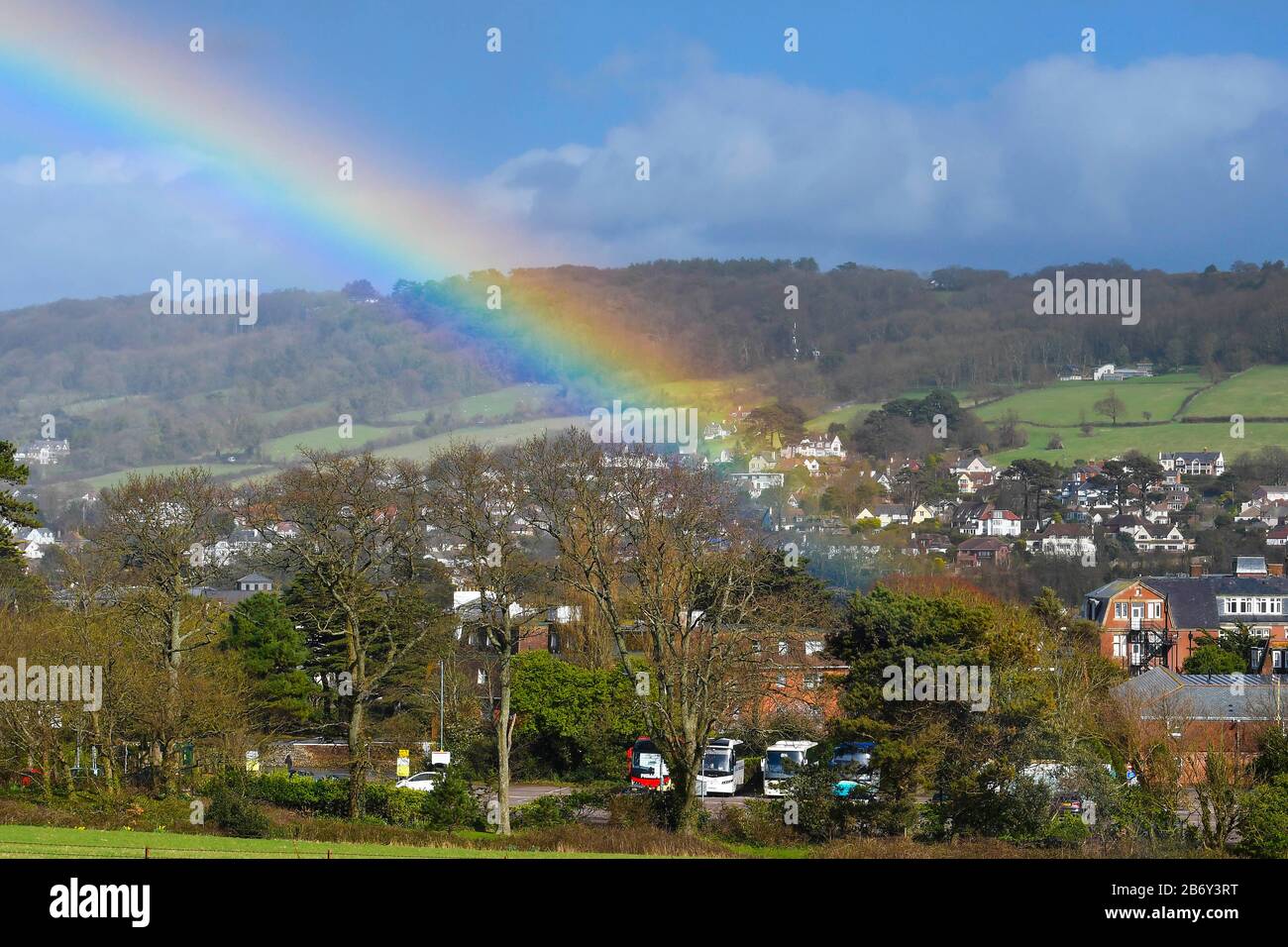 Sidmouth, Devon, UK. 12th March 2020. UK Weather. A rainbow arches