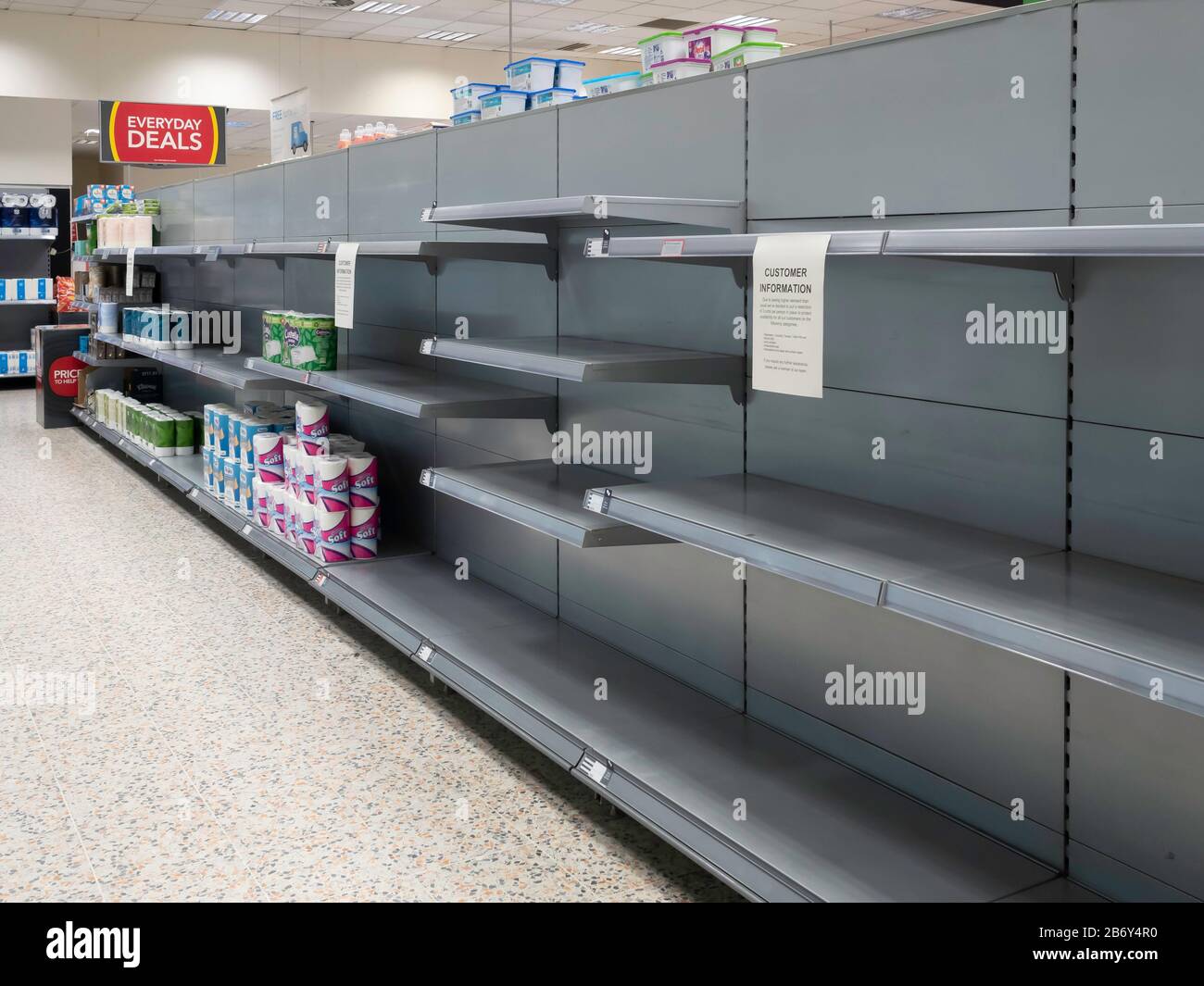 Empty shelves in a supermarket which usually contain tissues toilet ans kitchen rolls cleared by people concerned by supply difficulties due covid -19 Stock Photo