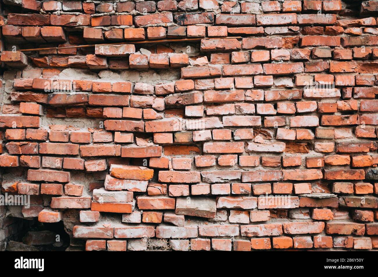 A crumbling red brick wall. Vintage background Stock Photo Alamy