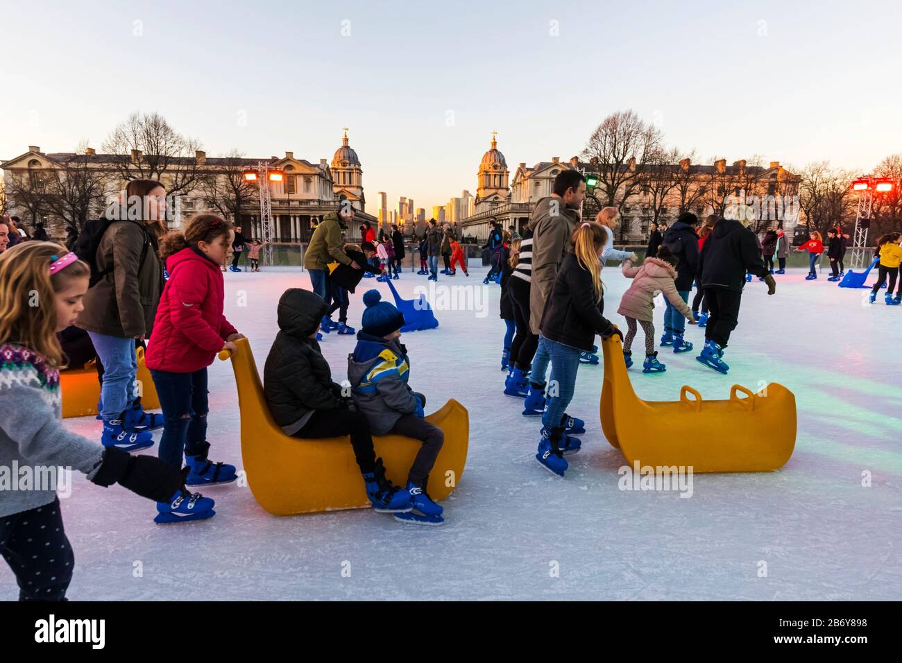 England, London, Greenwich, Adults and Children Ice Skating at The