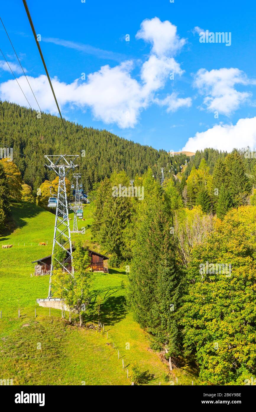 Grindelwald, Switzerland cable car cabins Jungfrau Top of Europe and green Swiss Alps mountains landscape Stock Photo