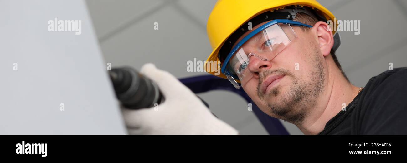 Worker with drilling machine Stock Photo