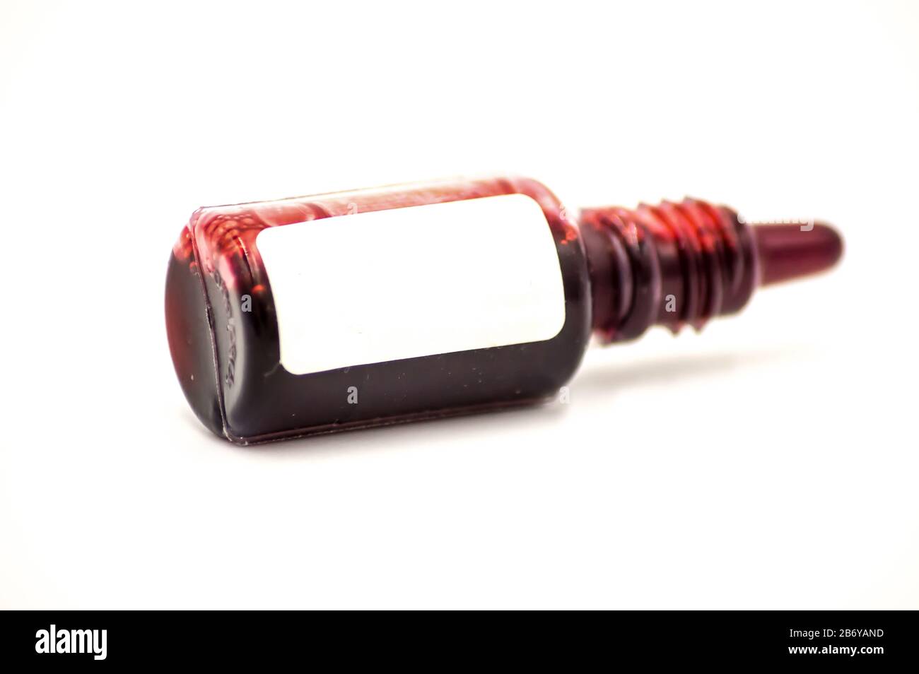 Studio macro of a pharmacy flask filled with red liquid on a white background. Copy space. Stock Photo