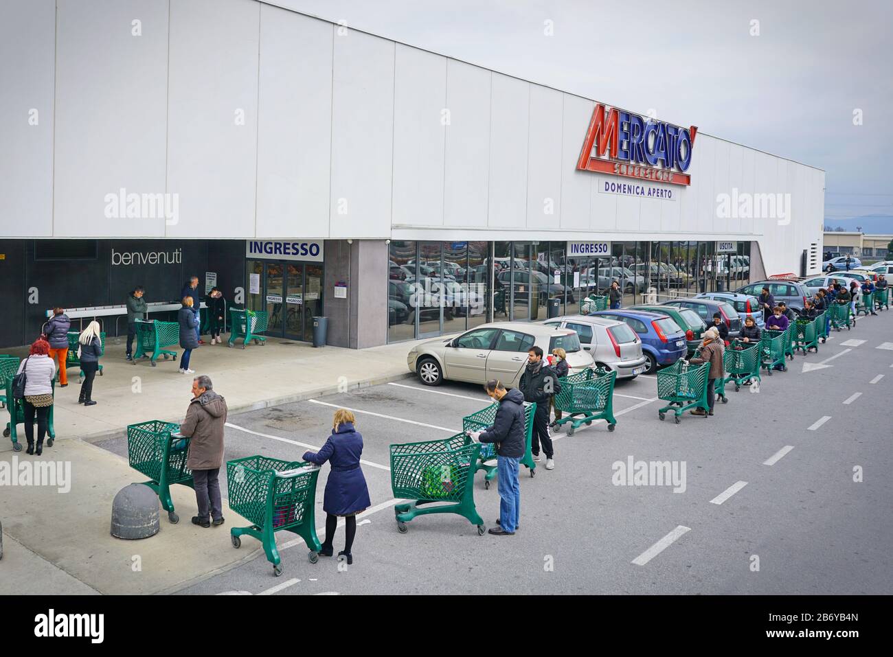 Coronavirus pandemic effects: long queue to enter the supermarket for grocery shopping. Milan, Italy - March 2020 Stock Photo