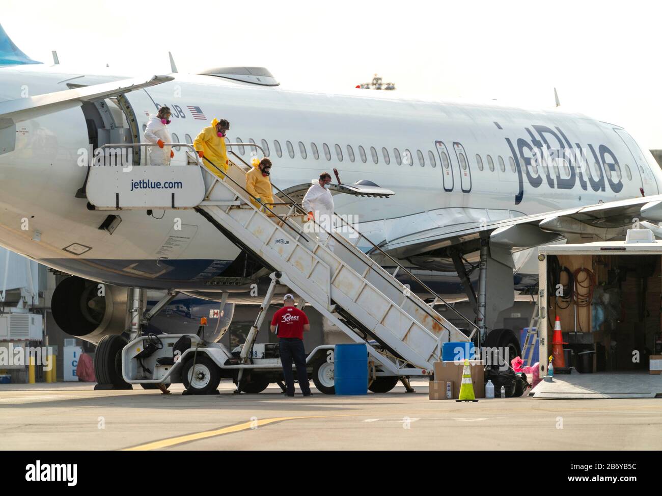 Mar 12, 2020; Palm Beach, FL, USA;   ACT Environmental Services crews clean a JetBlue plane after a flight from New York landed Wednesday night carrying a passenger who’d been infected with coronavirus at Palm Beach International Airport in West Palm Beach, Florida on March, 12, 2020.  Mandatory Credit: Greg Lovett/The Palm Beach Post/Sipa USA Stock Photo