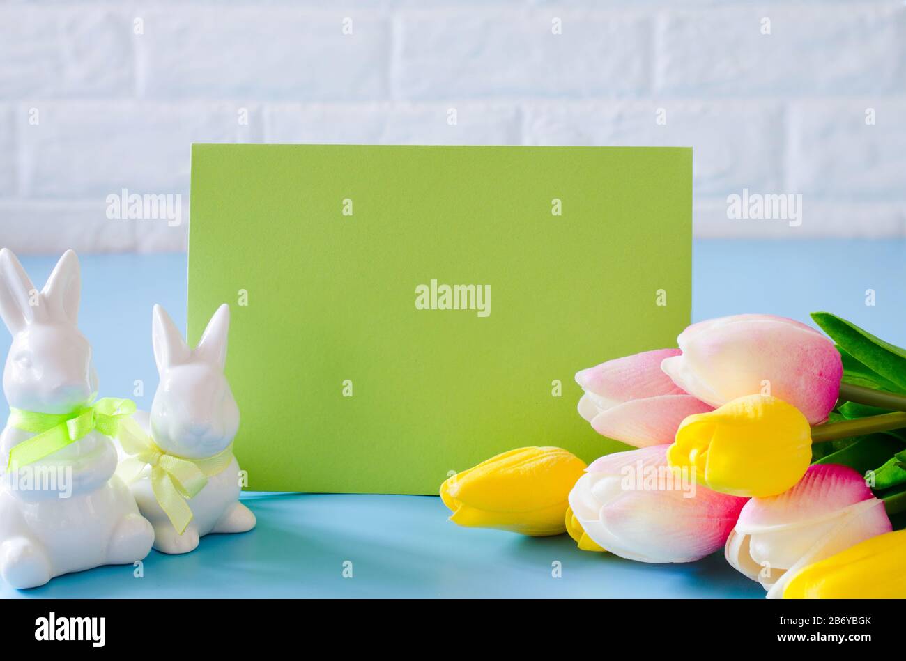 Happy Easter. Empty copyspace easter card. Easter background with decorative white rabbits. Stock Photo