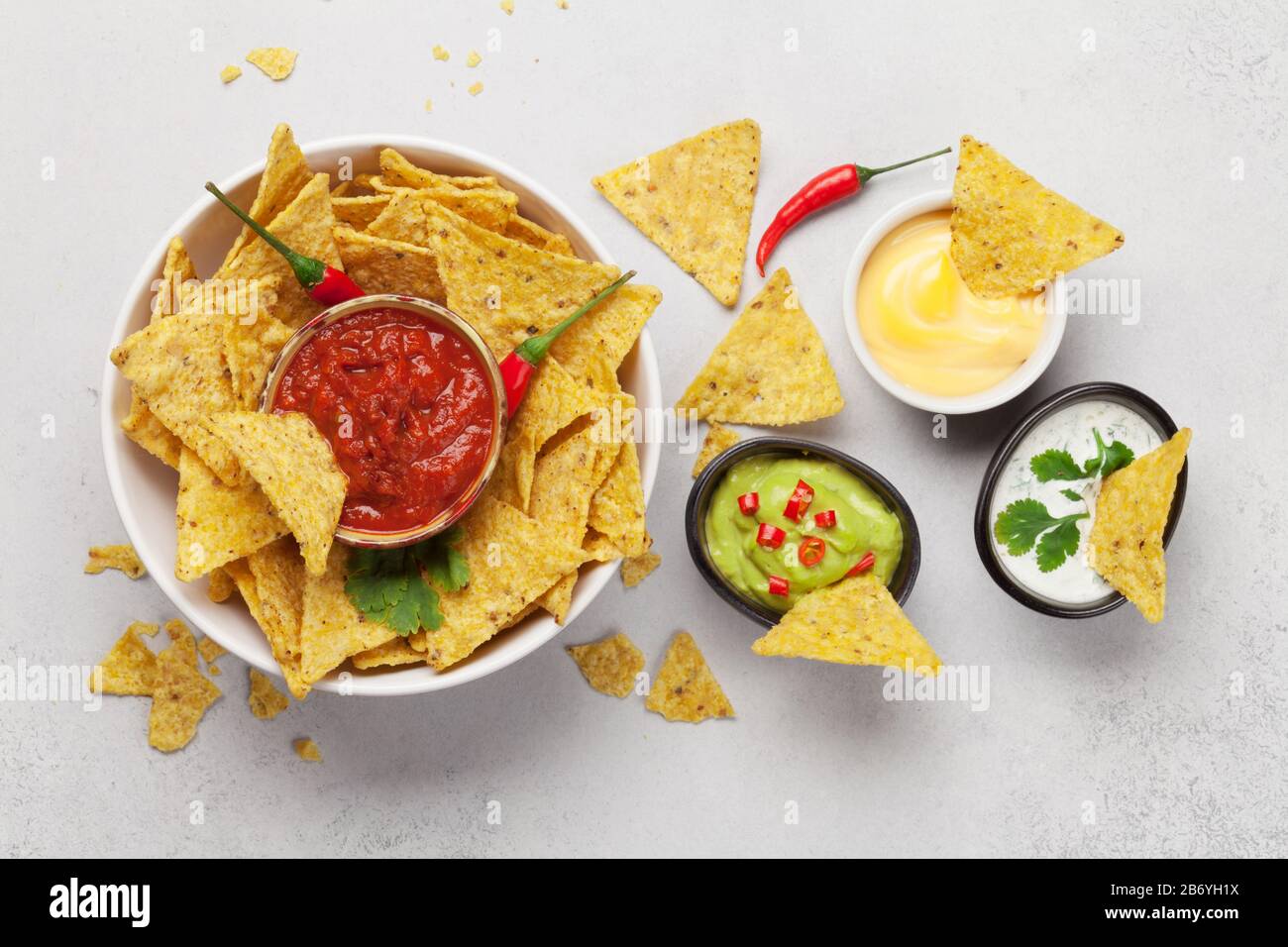 Mexican nachos chips with various sauces guacamole, salsa, cheese and