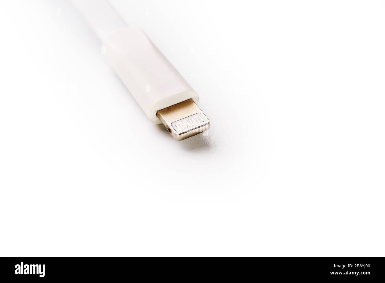 Connector lightning on a white background. This is a proprietary connector used to connect mobile devices to well-known host computers. Stock Photo