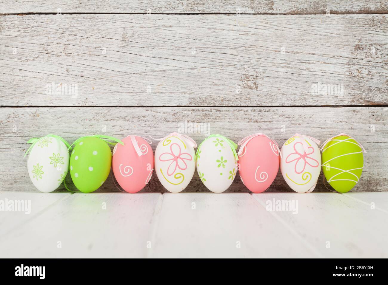 Easter greeting card with colorful easter eggs in front of wooden wall ...