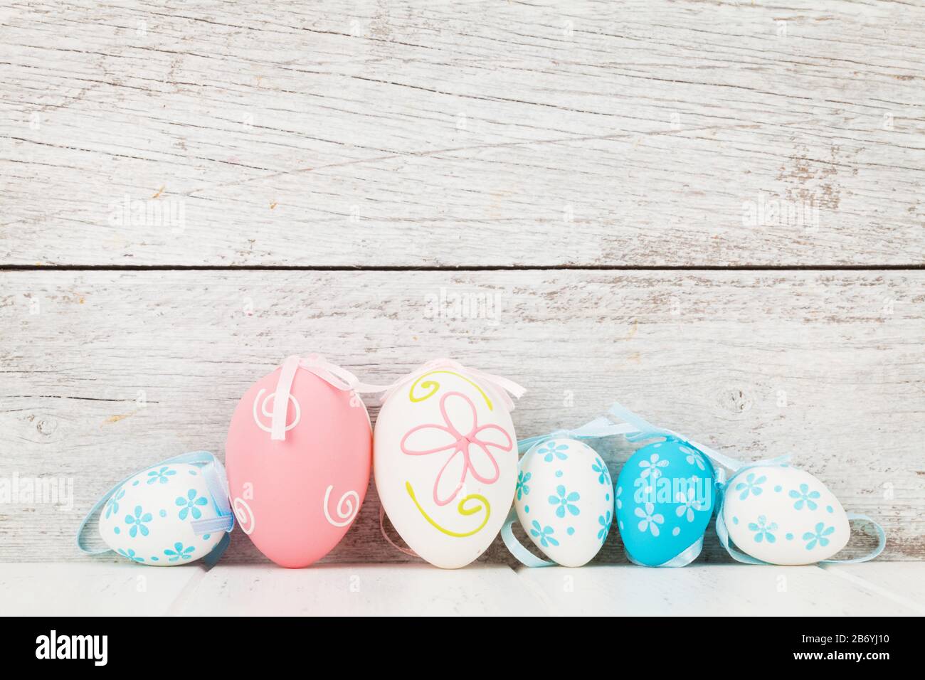 Easter greeting card with colorful easter eggs in front of wooden wall ...