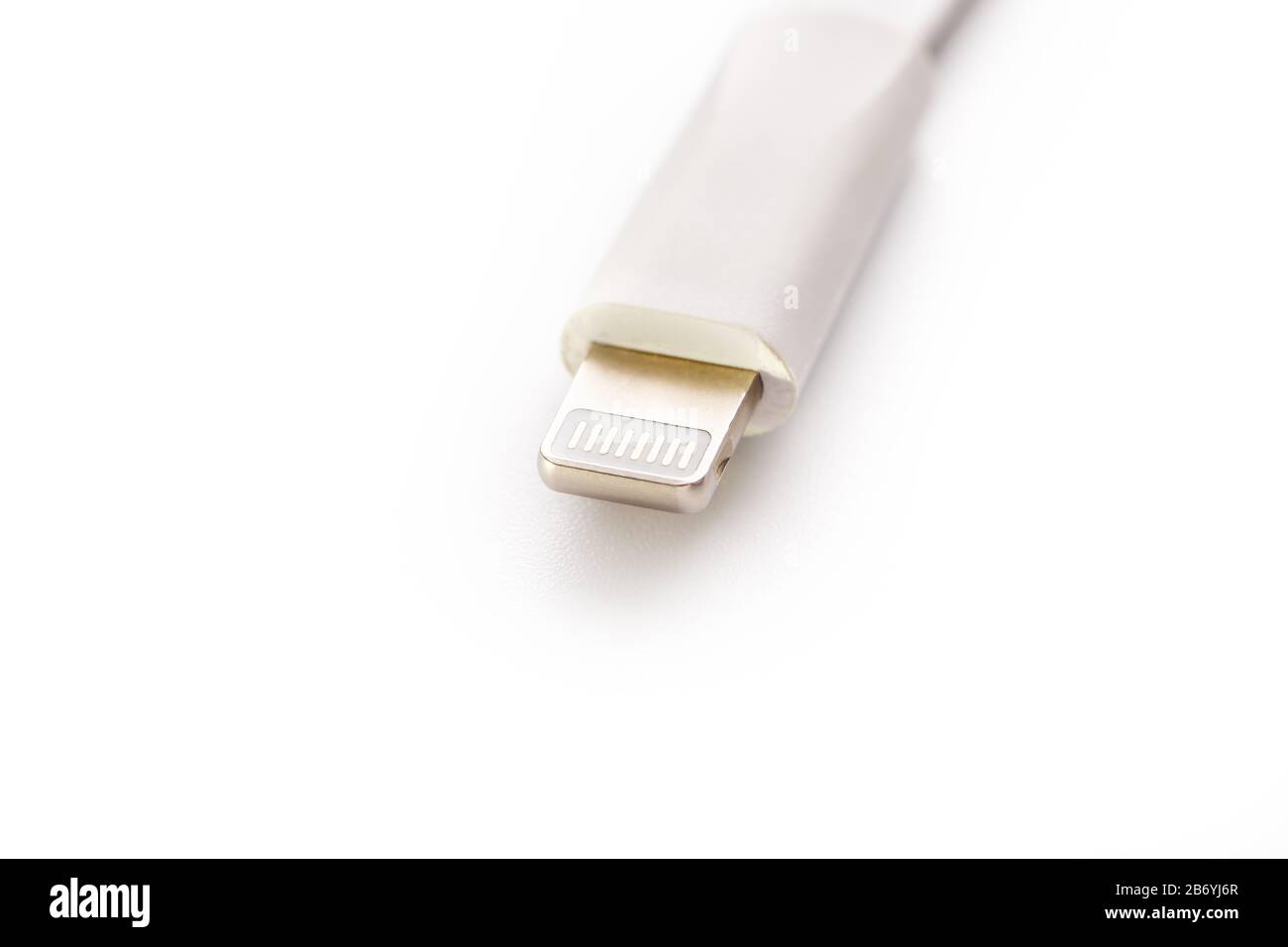 Connector lightning on a white background. This is a proprietary connector used to connect mobile devices to well-known host computers. Stock Photo