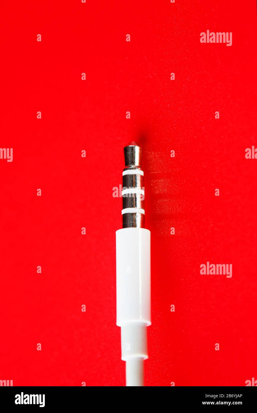 White connector auxiliary white cable on a red background Stock Photo