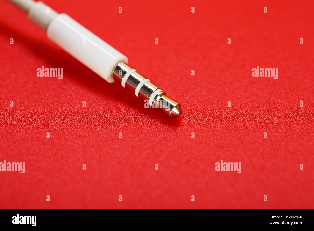 White connector auxiliary white cable on a red background Stock Photo