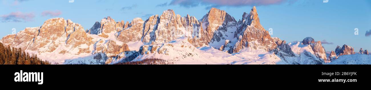 Panoramic view on the Pale di San Martino mountain group at sunset sunlight, alpenglow. The Dolomites of Trentino in winter. Italian Alps. Europe. Stock Photo