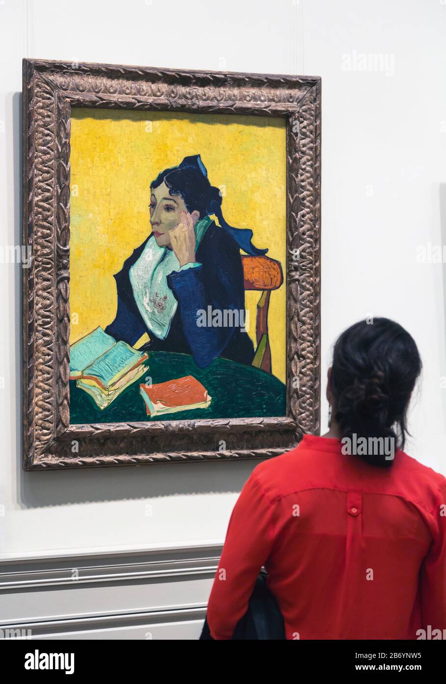 Visitor admiring L'Arlésienne: Madame Joseph-Michel Ginoux, by Vincent van Gogh on display in the Metropolitan Museum of Art, New York City, New York Stock Photo