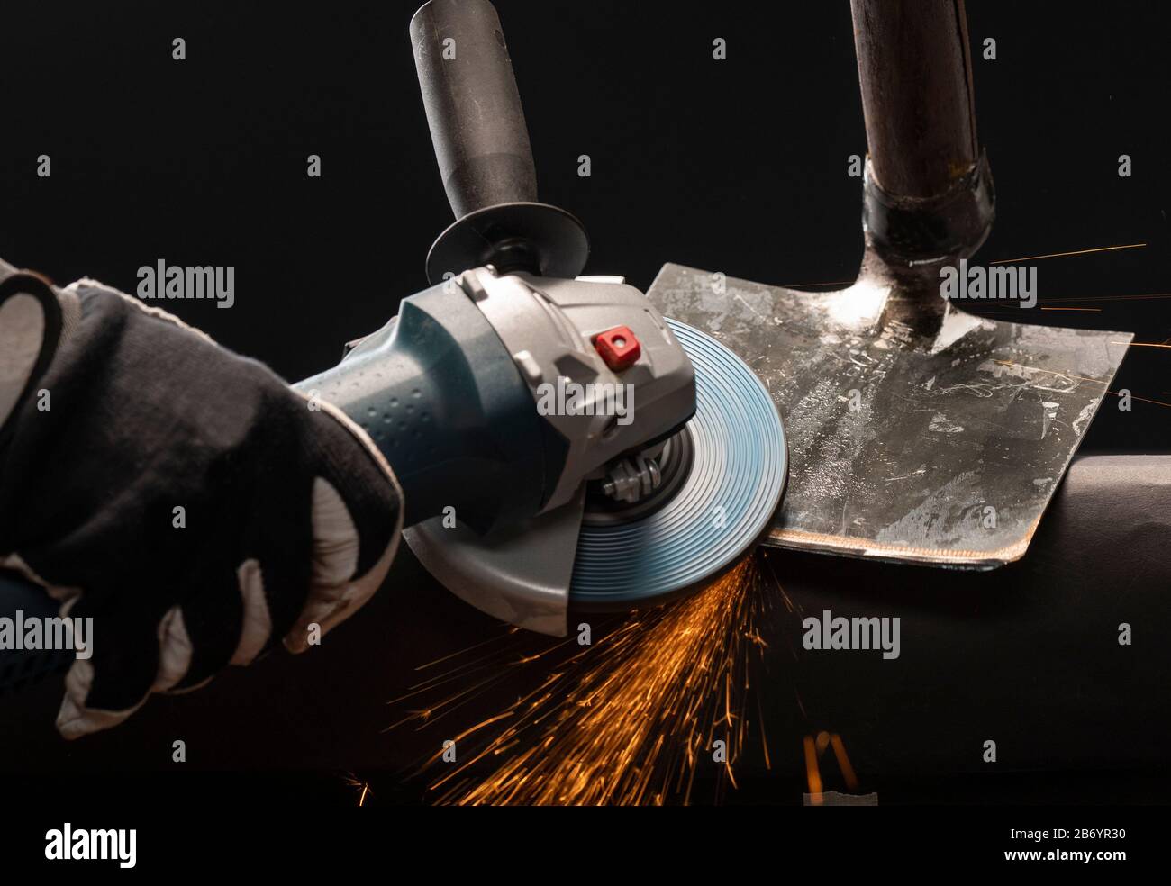 Sharpening garden shovel blade with electric angle grinder indoor Stock  Photo - Alamy