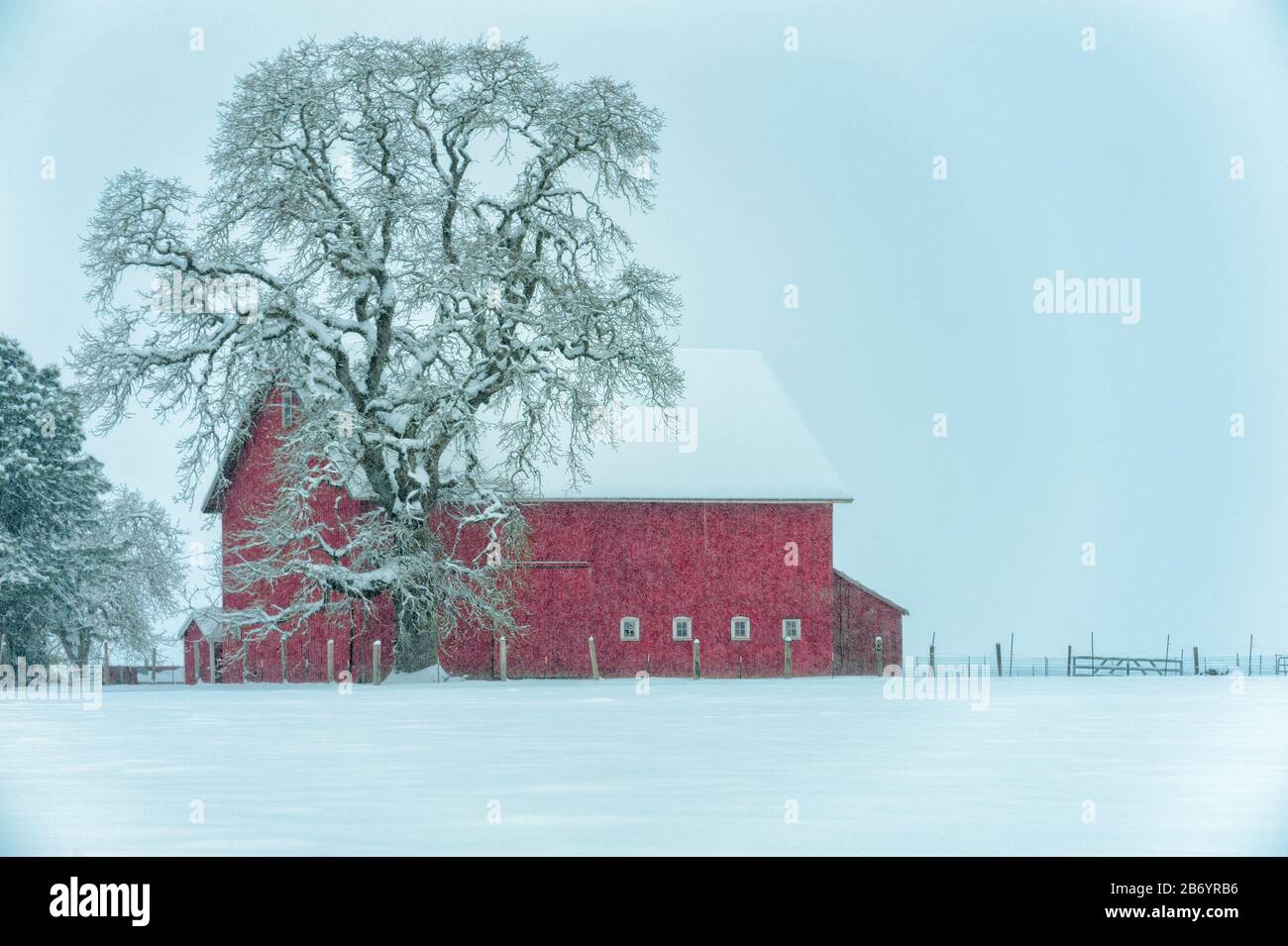Agricultural setting with red barn and winter landscape Stock Photo - Alamy