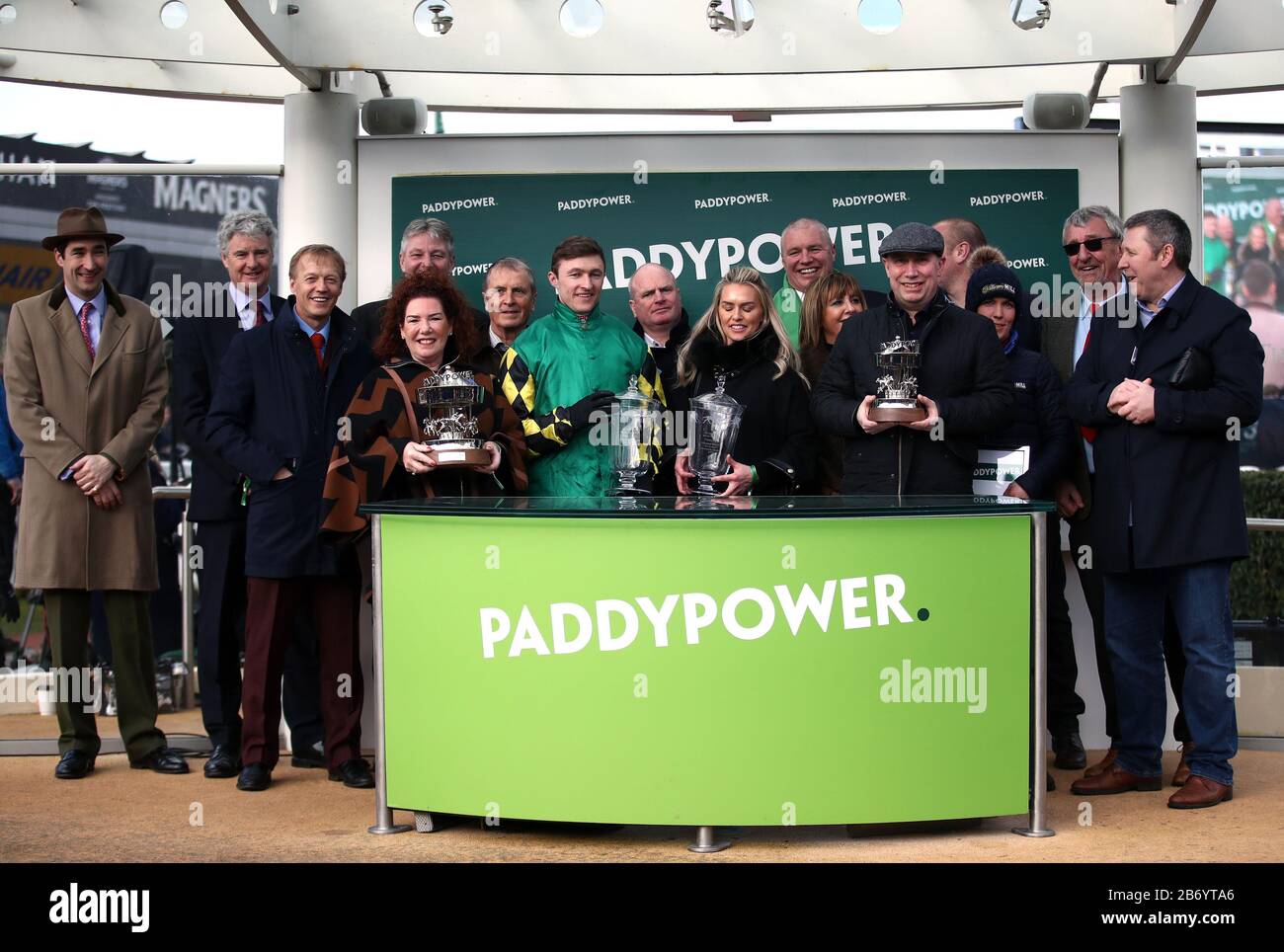 Jockey Adam Wedge celebrates winning the Paddy Power Stayers' Hurdle with trainer Rebecca Curtis and winning connections during day three of the Cheltenham Festival at Cheltenham Racecourse. Stock Photo