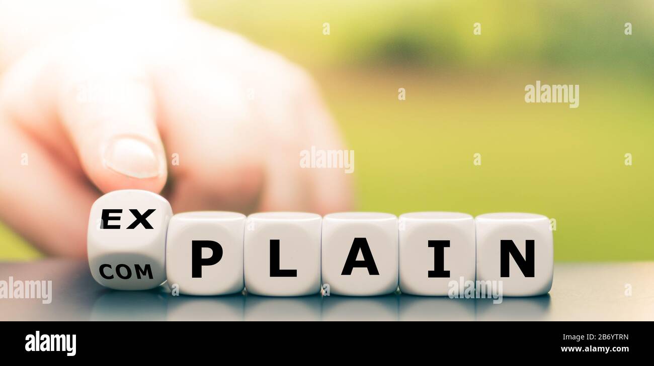 Explaining instead of complaining. Hand turns dice and changes the word 'complain' to 'explain'. Stock Photo