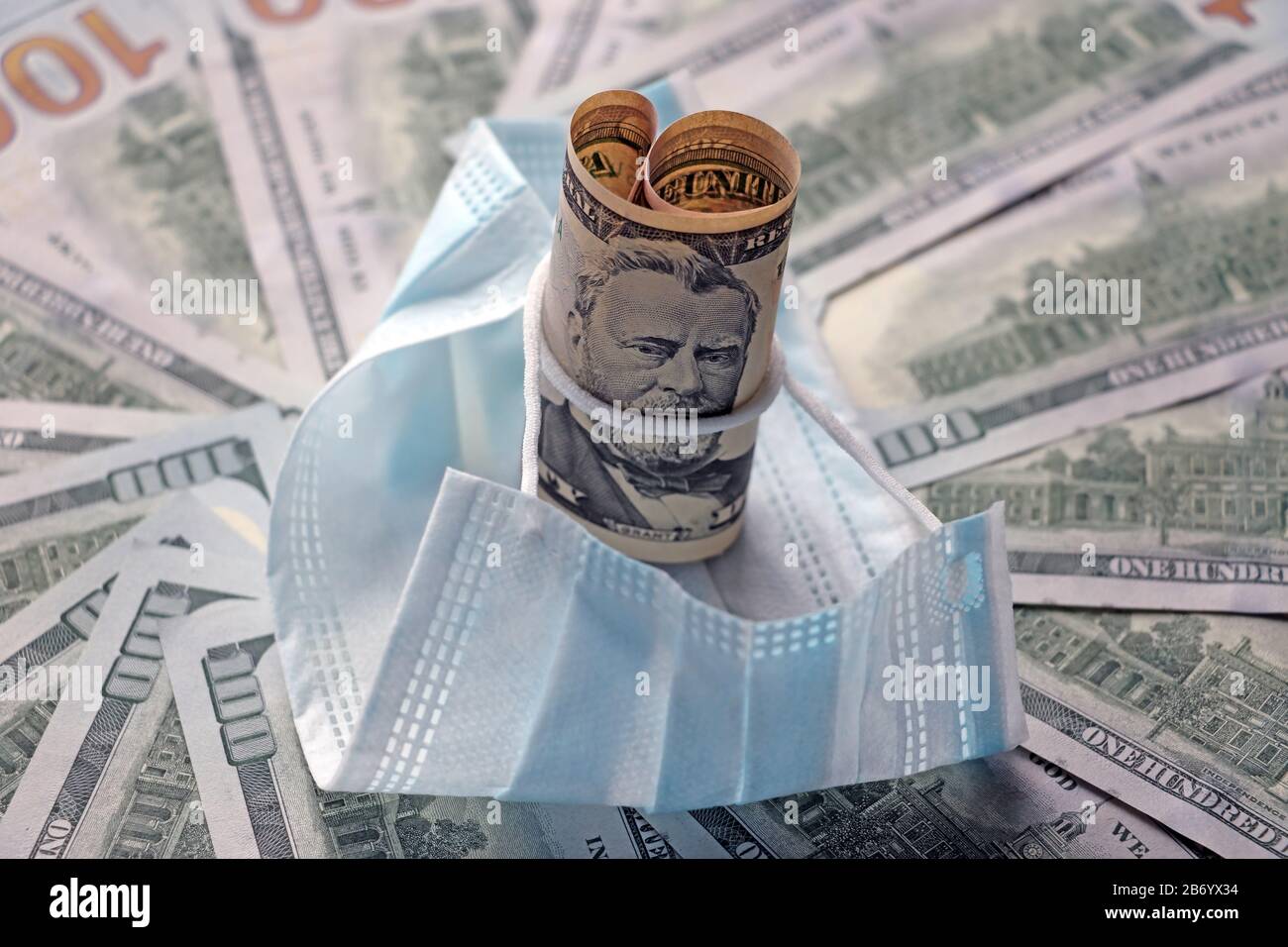 Medical mask on dollars as a symbol of increasing prices for protecting the respiratory tract from the virus. There is a place for copyspace Stock Photo
