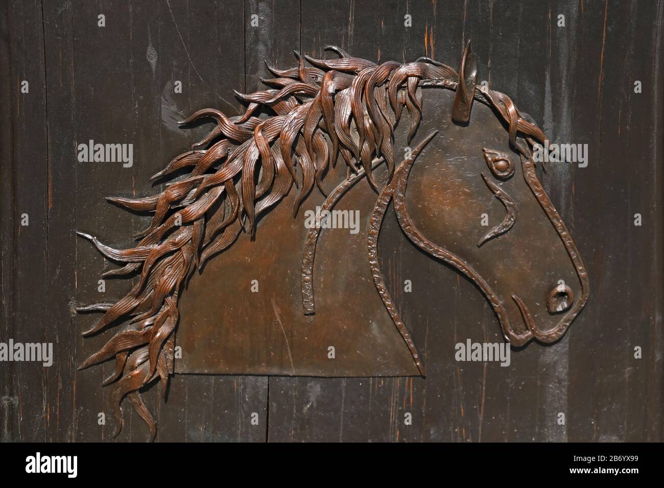 Iron wall or door with a horse symbol Stock Photo Alamy