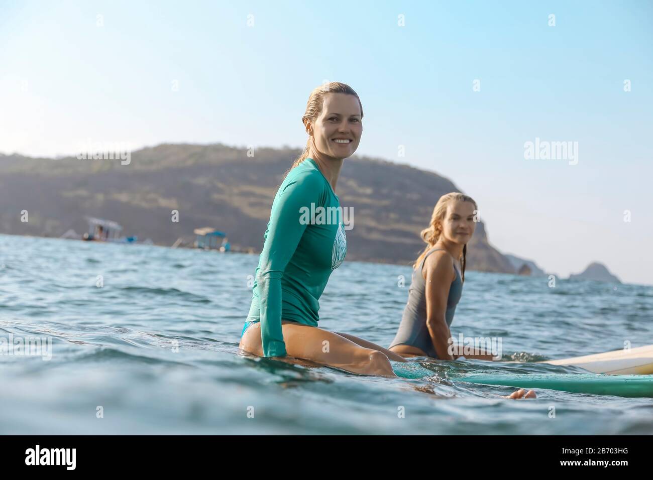 Young female surfers on surfboard Stock Photo