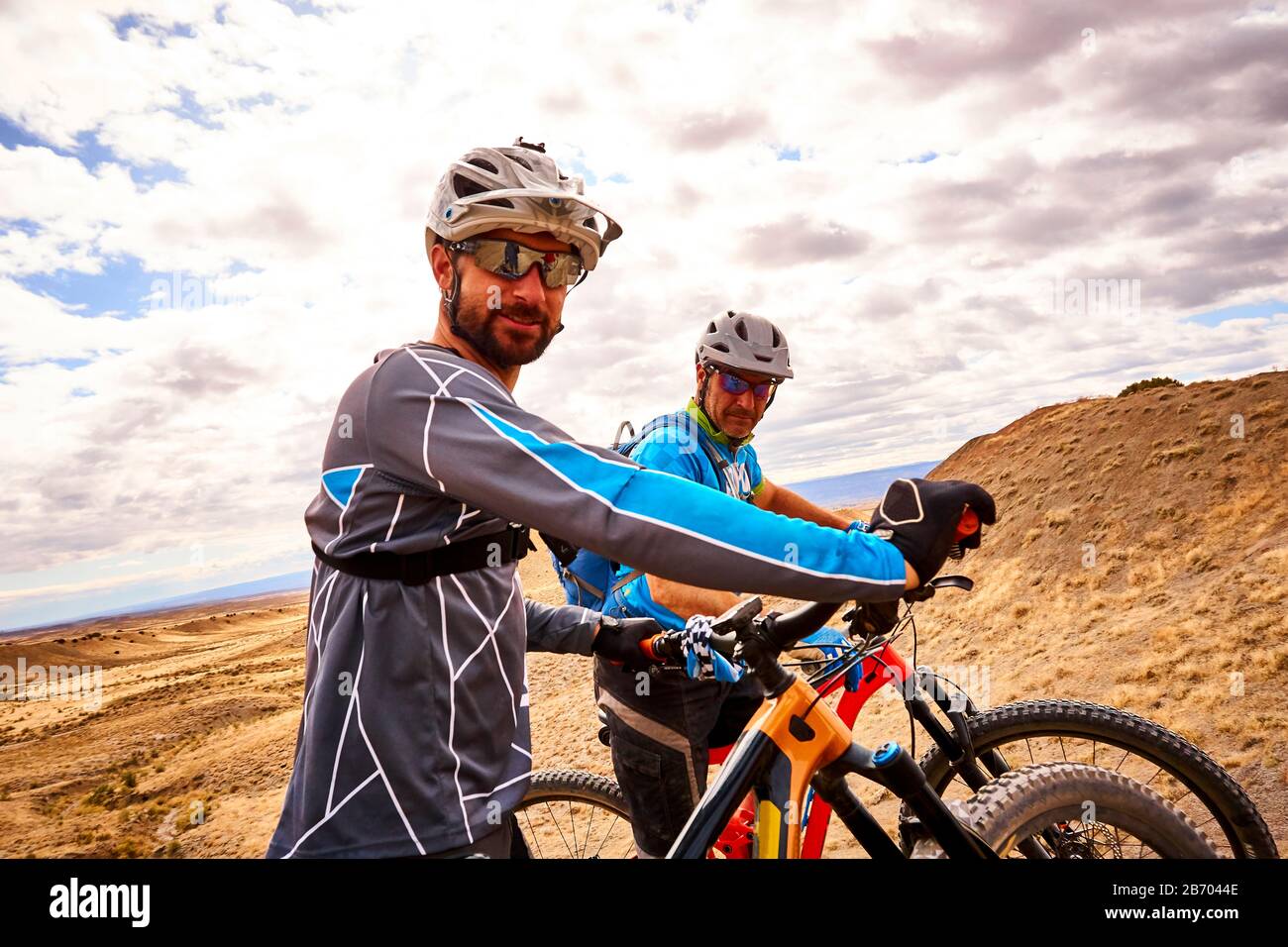 A candid portrait of two mountain bikers. Stock Photo
