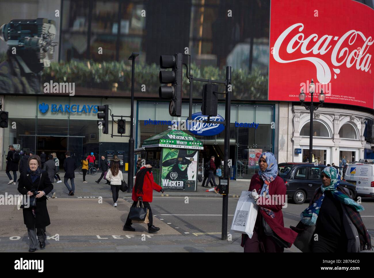 incomplete Road making process dock Londoners and visitors to London walk through Piccadilly Circus where digital advertising is being displays on the large screens above a branch of Barclays Bank and Boots the Chemist, on 6th March incomplete Road making process dock Londoners and visitors to London walk through Piccadilly Circus where digital advertising is being displays on the large screens above a branch of Barclays Bank and Boots the Chemist, on 6th March