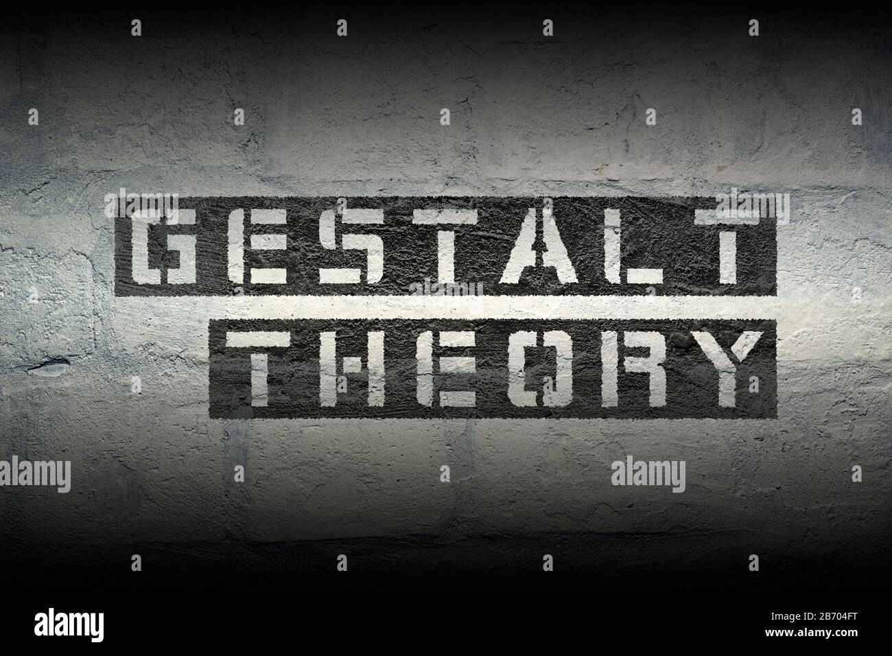 gestalt theory phrase stencil print on the grunge white brick wall Stock Photo