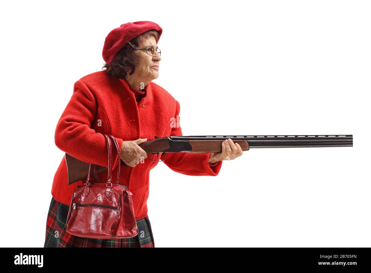 Grandmother in a red coat holding a shotgun isolated on white background Stock Photo