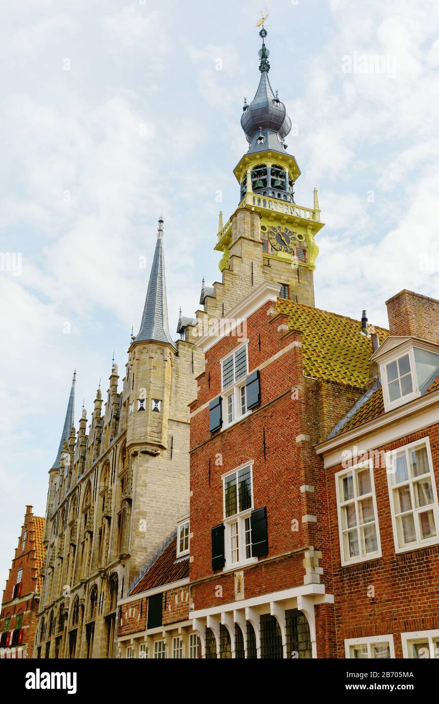 historic houses with the steeple of the historic town hall in Veere, Netherlands Stock Photo