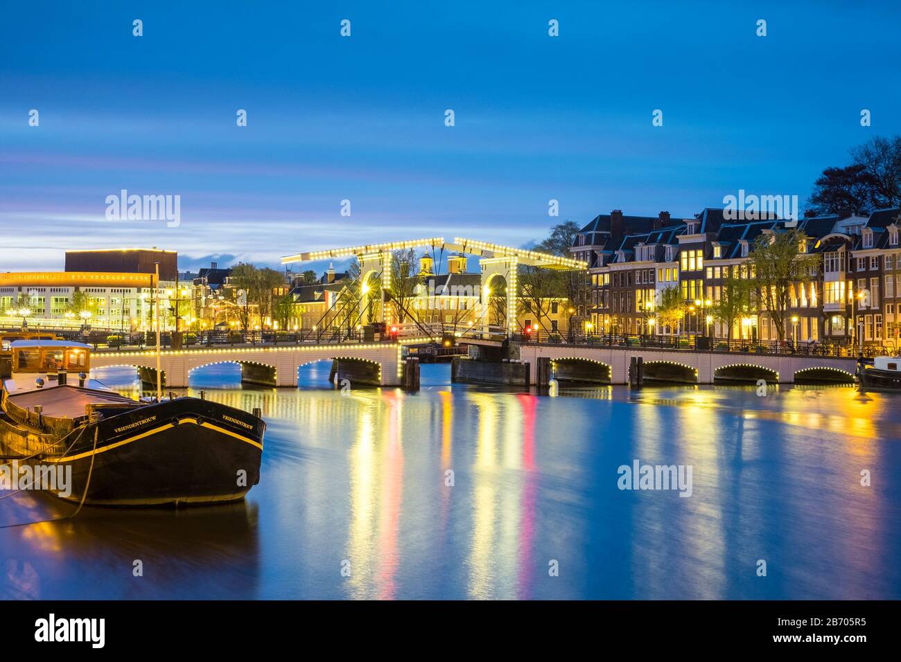 Netherlands, North Holland, Amsterdam. Magere Brug, Skinny Bridge, on the Amstel River at night. Stock Photo
