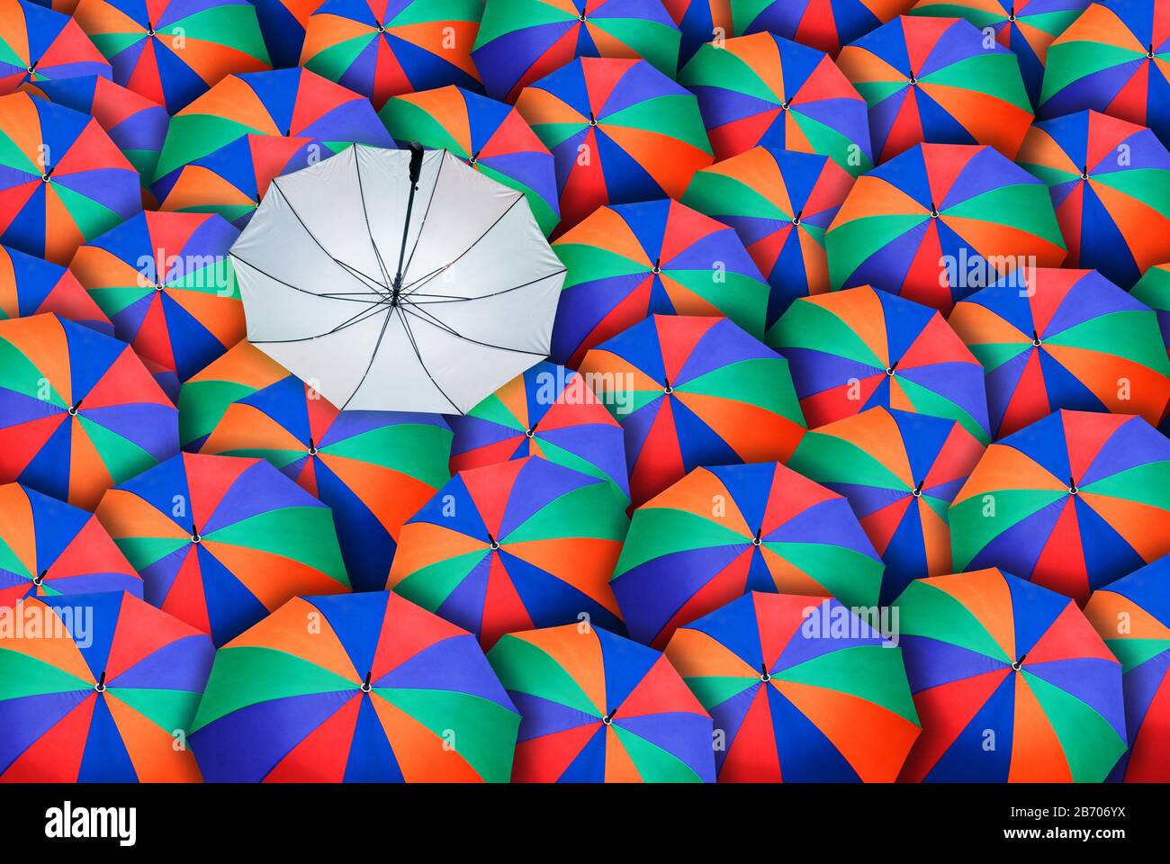 Colorful umbrella in mass of black umbrellas Stock Photo Alamy