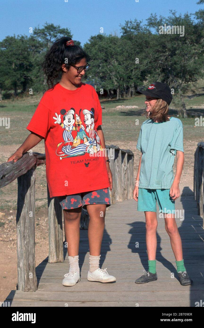 Bandera Texas USA: Fifth-grade girls talk during elementary school field trip in Texas Hill Country, showing size difference of girls the same age as puberty sets in at different times. MR ©Bob Daemmrich Stock Photo