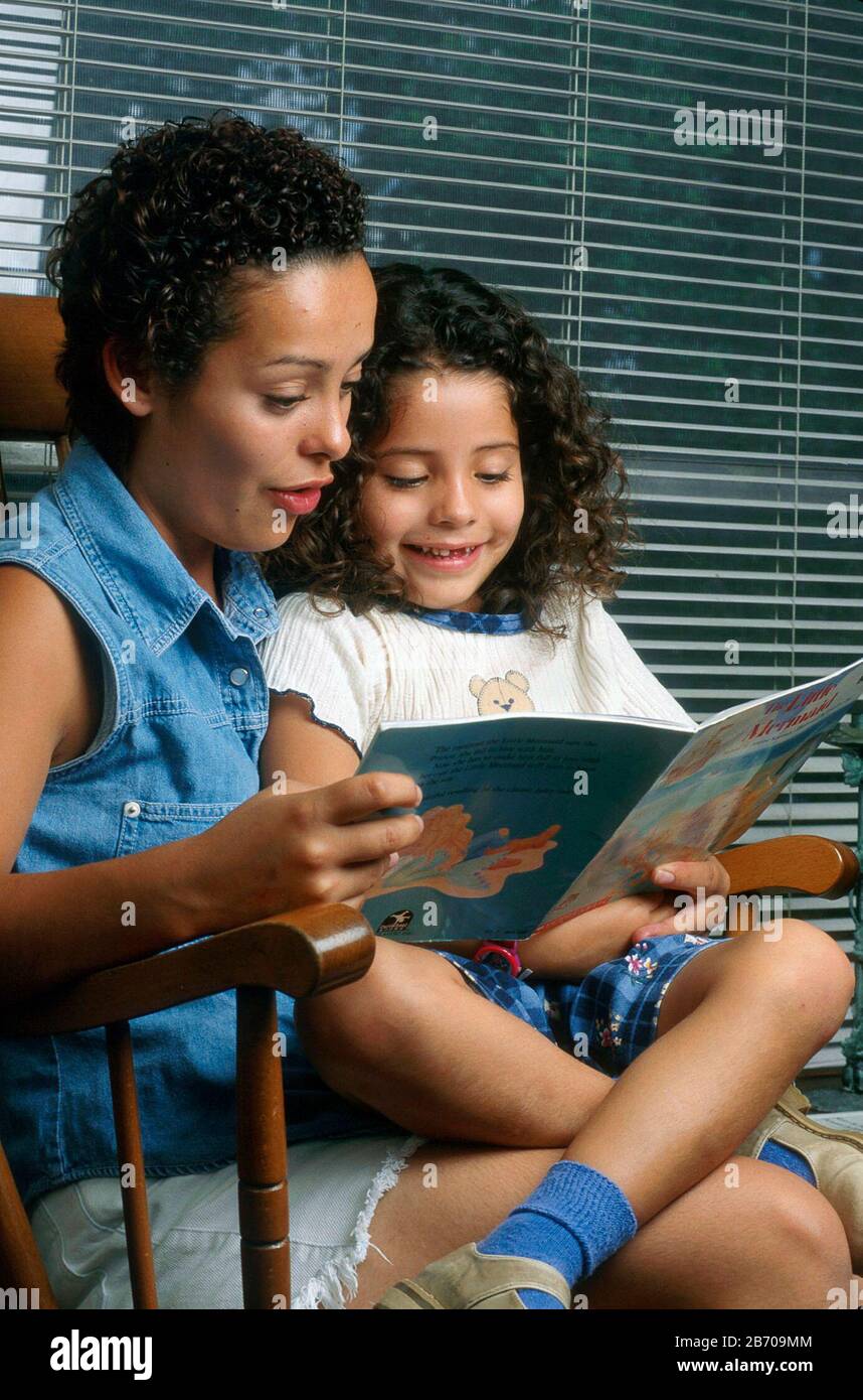 Austin Texas USA: Single 20-year-old Mexican-American mom reading with four-year-old daughter. MR ©Bob Daemmrich Stock Photo