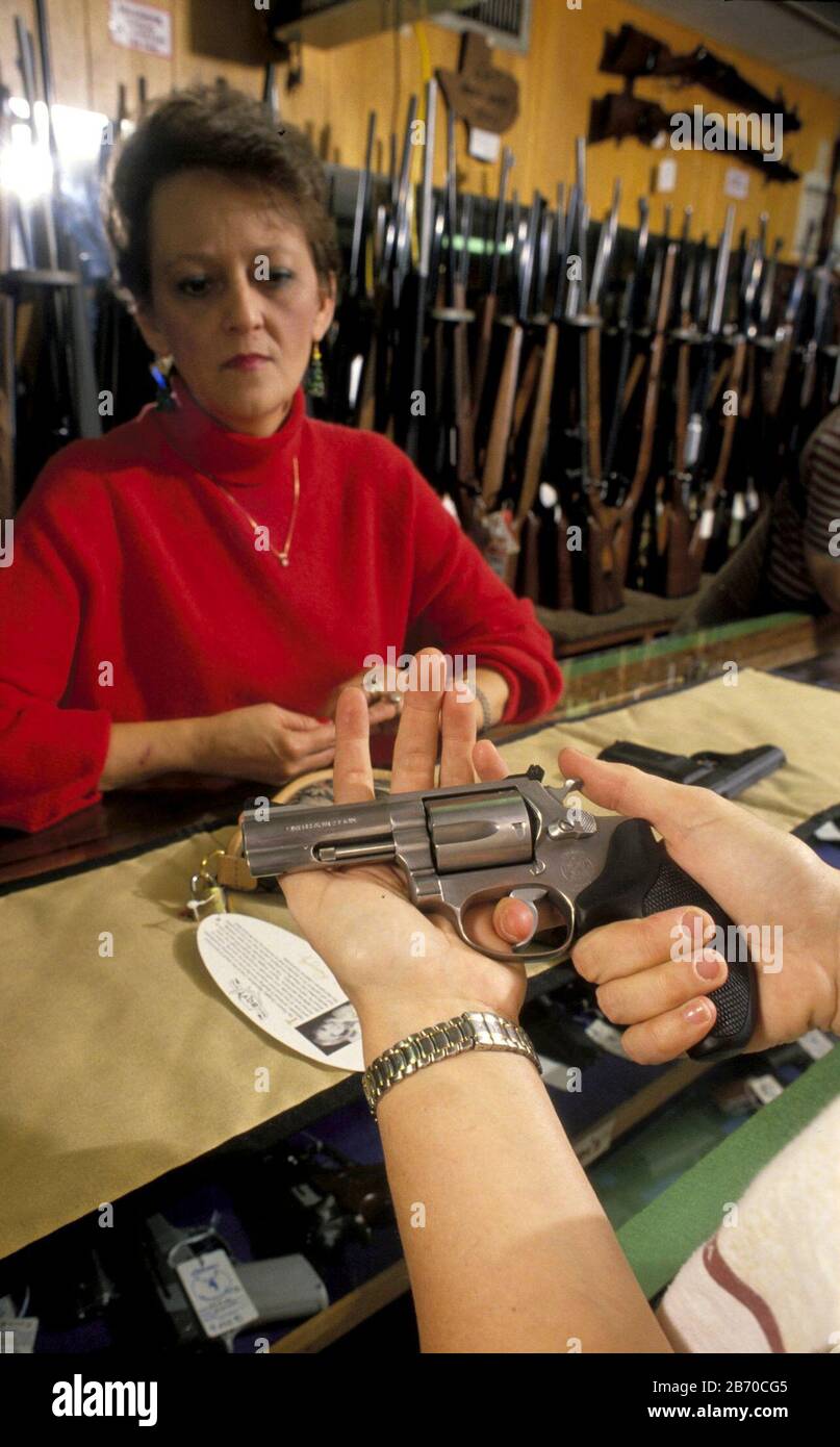 Austin, Texas USA: Woman shopping for handgun at McBride's Gun & Hunting Goods store. MR  ©Bob Daemmrich Stock Photo