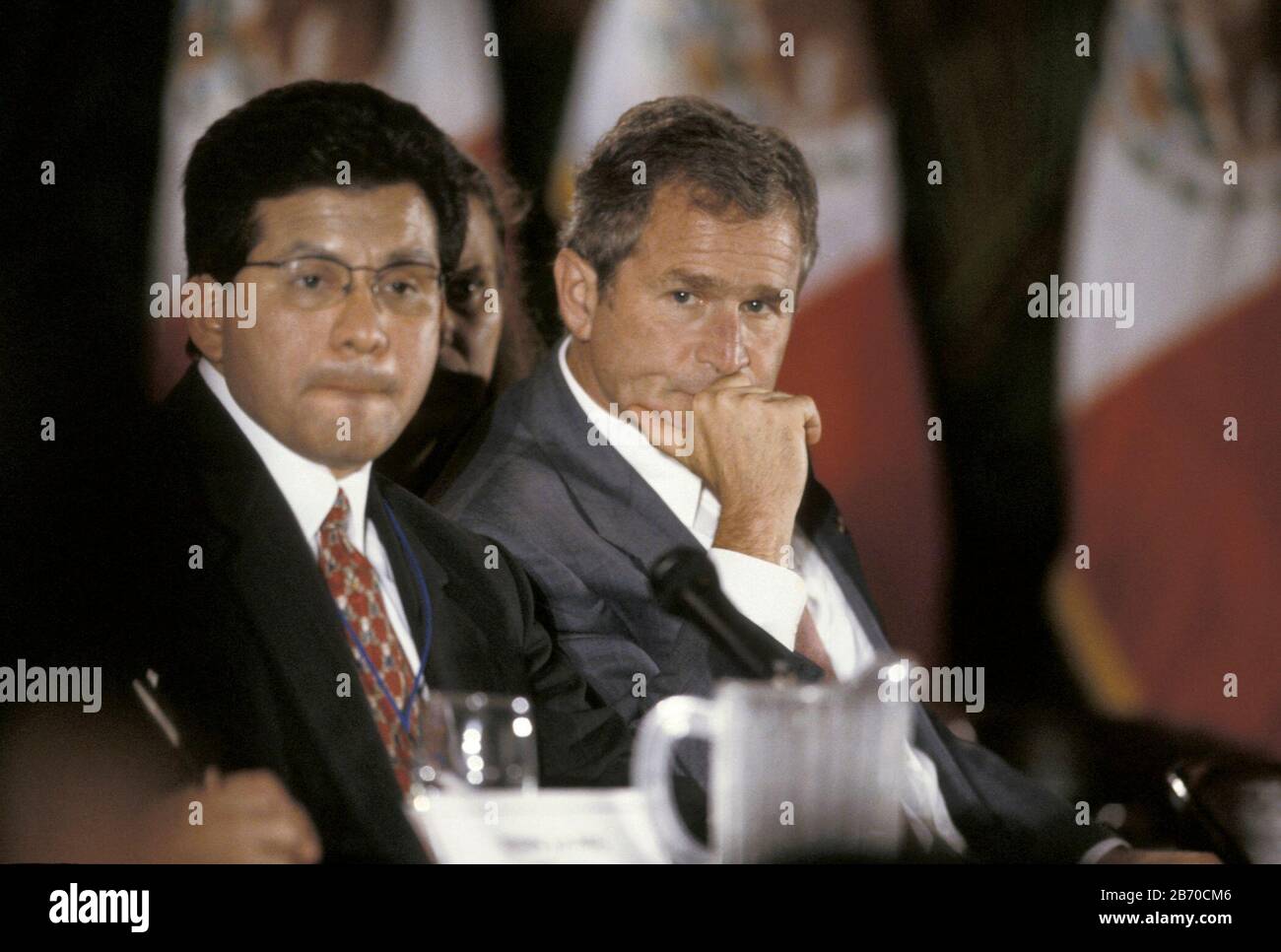 Brownsville, Texas USA, 1998: Texas Gov. George W. Bush and Texas Secretary of State Alberto Gonzales listen to speaker at Border Governors Conference. ©Bob Daemmrich Stock Photo