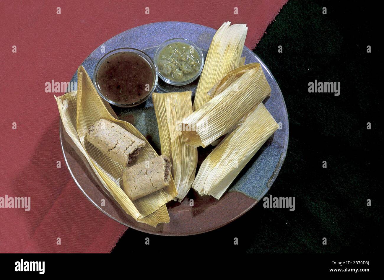 Plateful of bean tamales with salsa verde (green sauce) and salsa rojo (red sauce). ©Bob Daemmrich Stock Photo