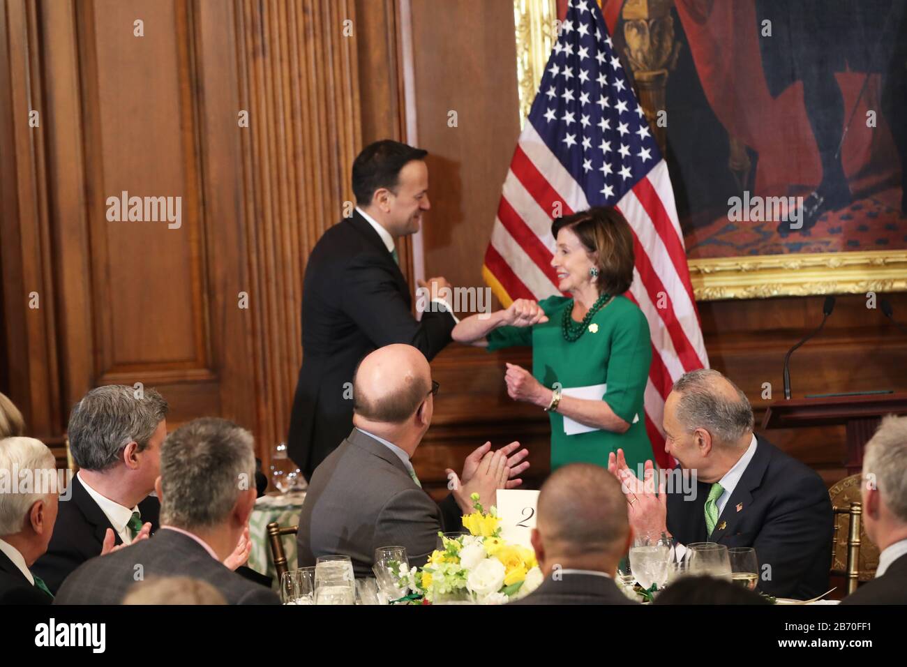 Nancy Pelosi, speaker of the United States House of Representatives, greets Taoiseach Leo Varadkar with a playful elbow bump, as he heads on stage at the Speaker???s luncheon on Capitol Hill in Washington DC during his visit to the US. Stock Photo