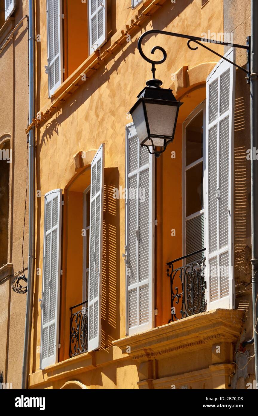 Lamp and sunwashed wall in Aix en Provence, France. Stock Photo