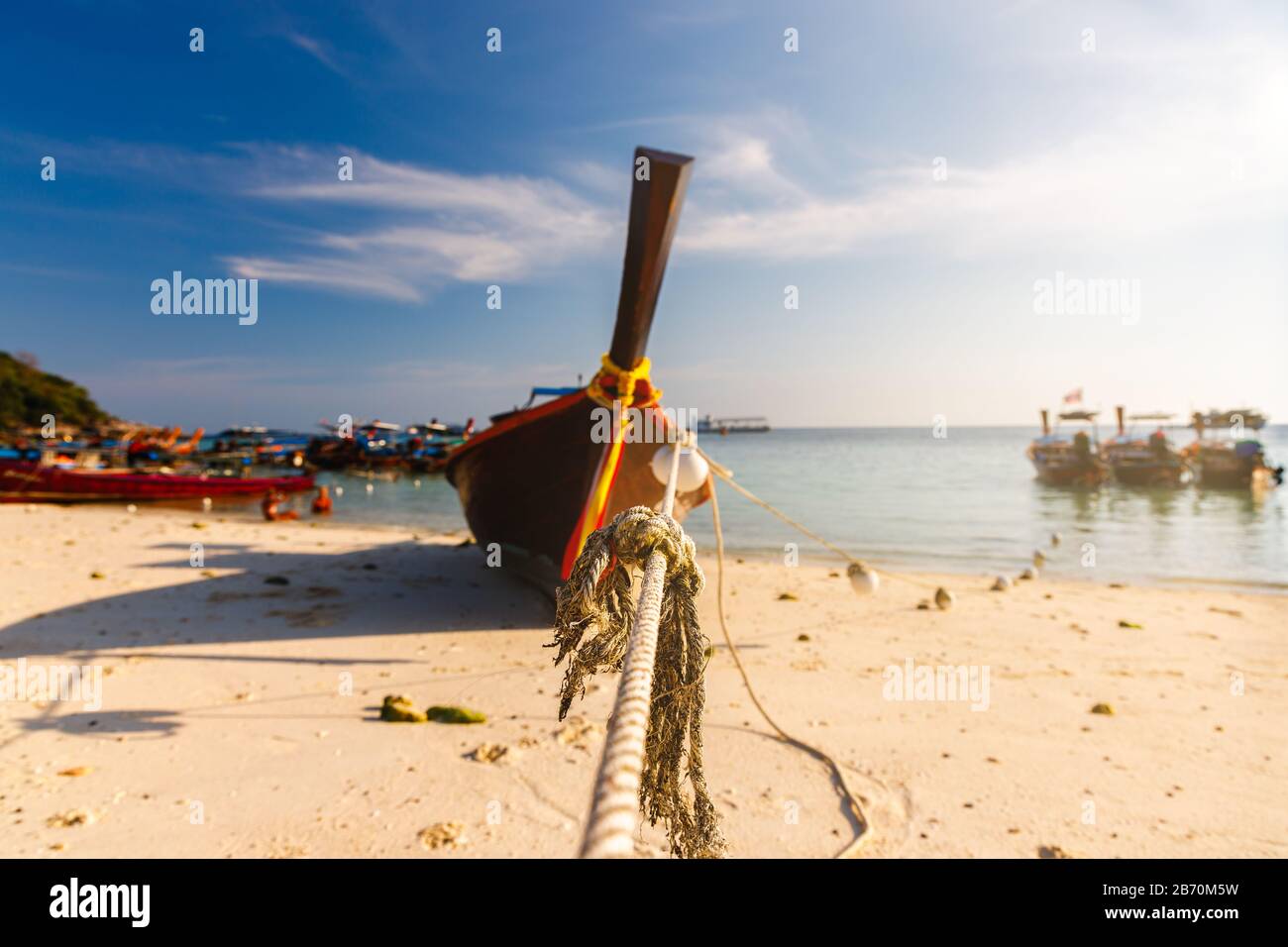 Mooring rope and long tail boat on the beach on  island of Andaman Sea ,southern of Thailand, with summer blue sky. Stock Photo