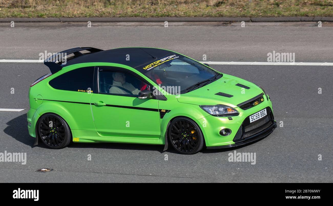 Motor Sport Developments 2010 green Ford Focus RS; UK vehicular traffic,  transport, modern vehicles, saloon cars, moving vehicles, vehicle, roads,  motors, motoring on the M6 motorway highway Stock Photo - Alamy