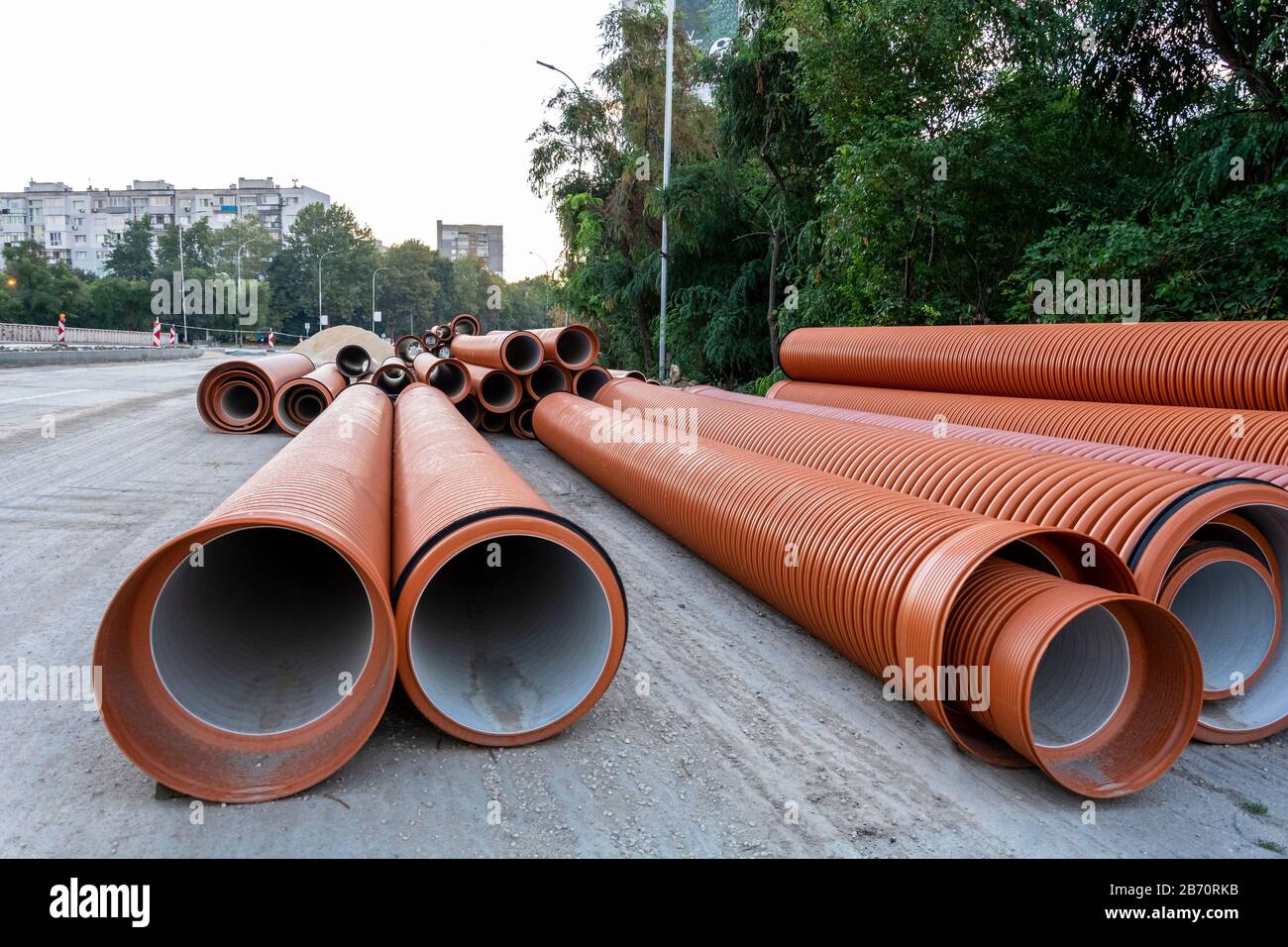 Pvc Pipeline stacked on the road, road construction with pipes Stock