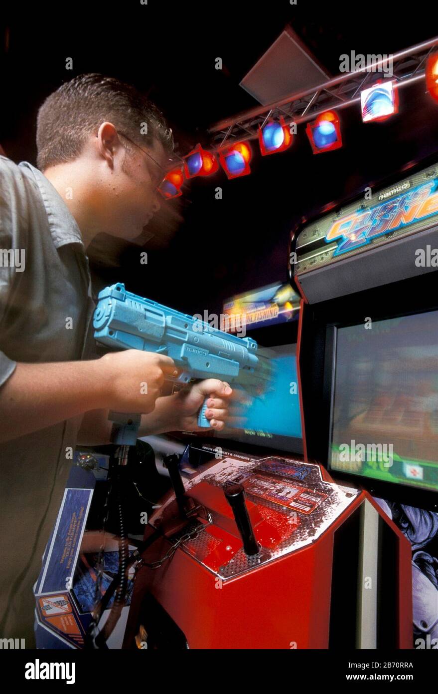 Austin Texas USA: 13-year-old boy playing violent video game at arcade. MR  ©Bob Daemmrich Stock Photo - Alamy